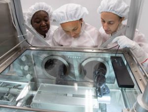 Date: 11-05-19 Location: Bldg. 31 – Lunar Curation Lab Subject: ARES team extruding Apollo lunar core sample. Pictured are from left, Andria Mosie, Charis Krysh and Juliane Gross Photographer: James Blair