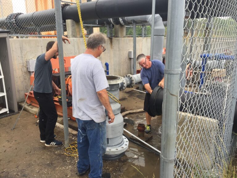 Sean Towers, Dave Jones, and Mark Baranoski work to repair one of AIC’s seawater intakes. Photo credit: David Bushek.