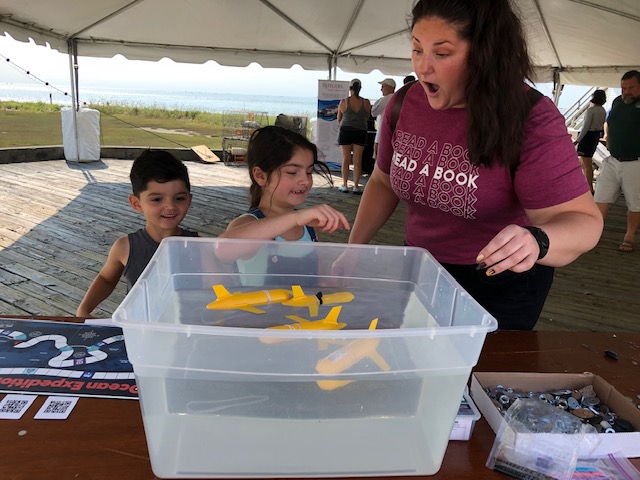 Kathleen Sanchez, children’s librarian at Ocean County Library with her children, exploring one of the Explorers of the Deep kit activities.