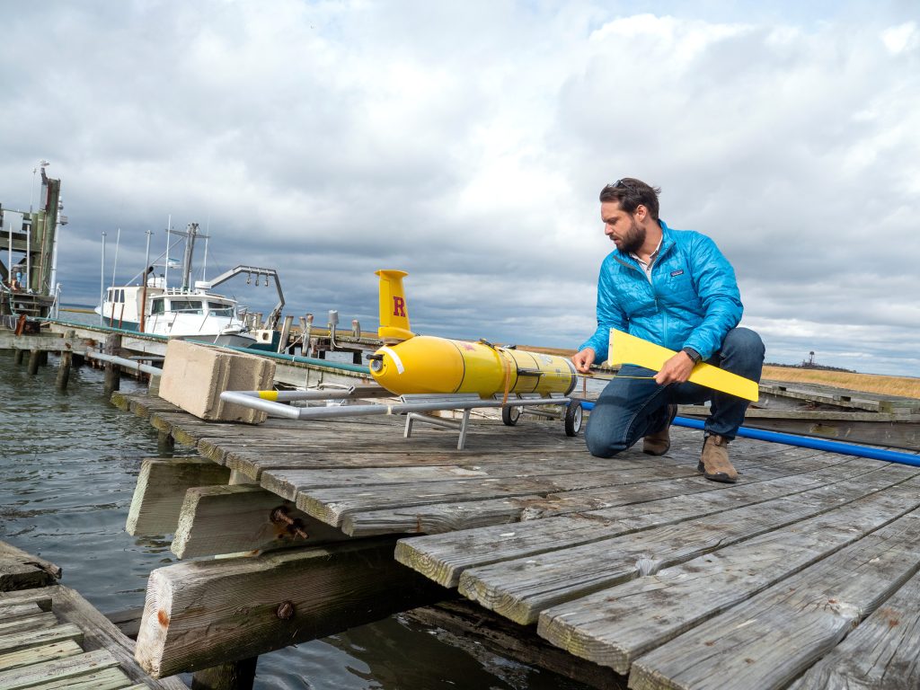 Travis Miles inspects a Rutgers ocean glider at the Marine Field Station on the Mullica Hill Estuary. Photo: Shelley Kusnetz
